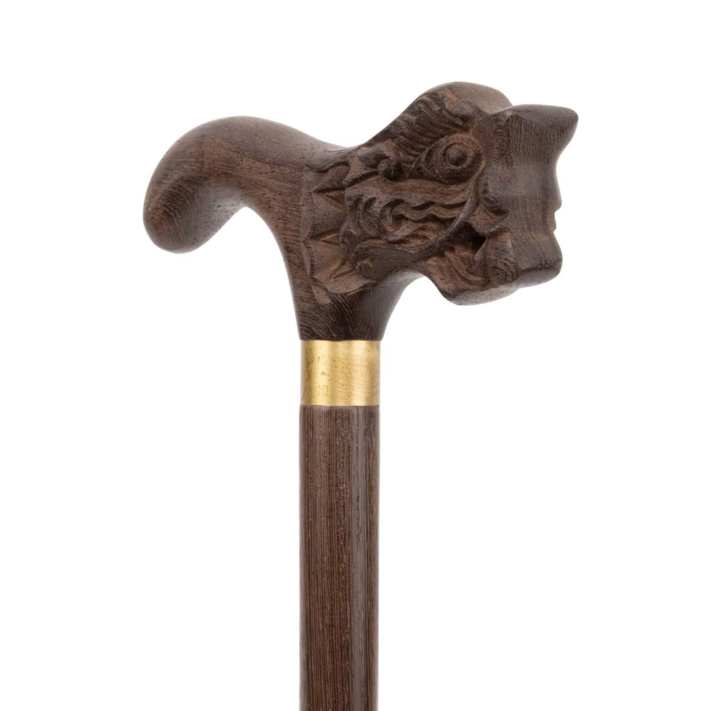 Carved dragon head handle in dark wood, close-up