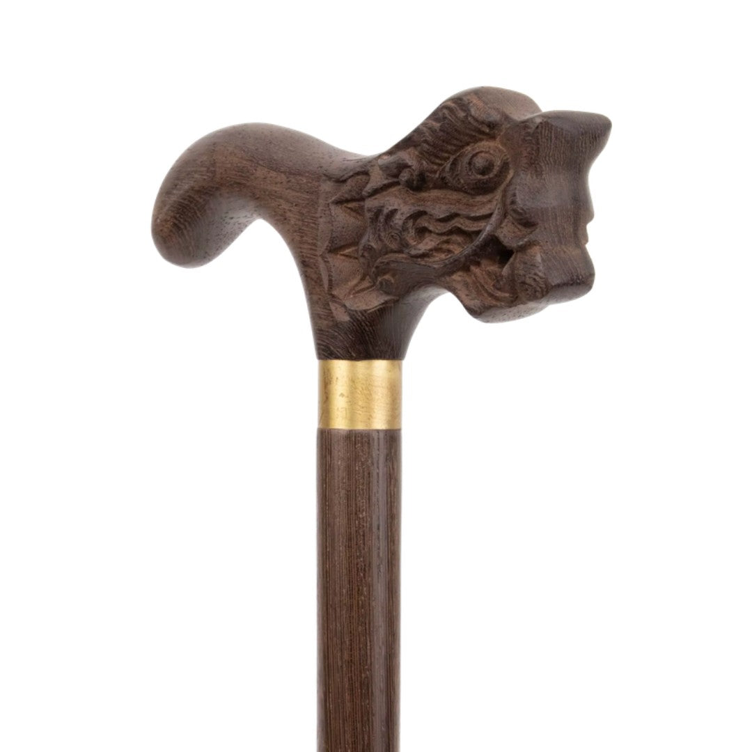 Carved dragon head handle in dark wood, close-up